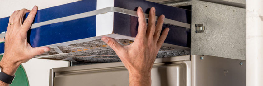 a person changing an air filter