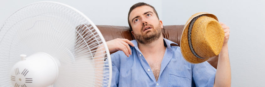 a man in front of a fan
