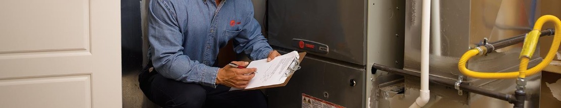 technician inspecting a furnace