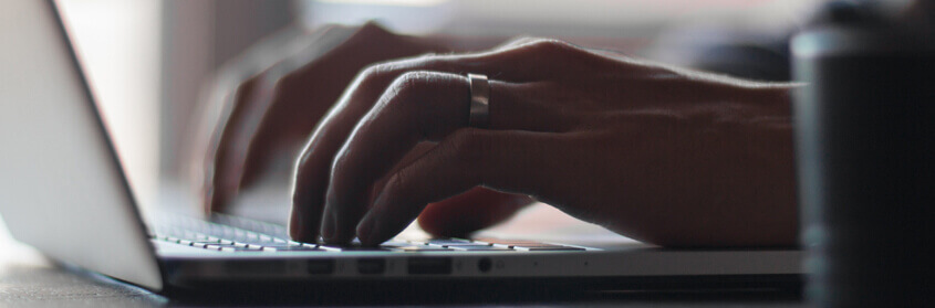 a person typing on a keyboard