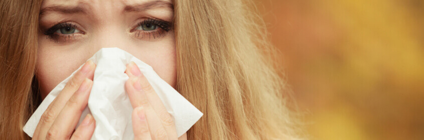 a woman blowing her nose