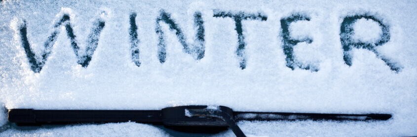 winter written in snow on a windshield