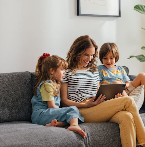 Family reading on the couch enjoying comfort thanks to a recent Walker HVAC repair