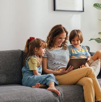A happy family in Jenison enjoying screen time in their living room after AC service.