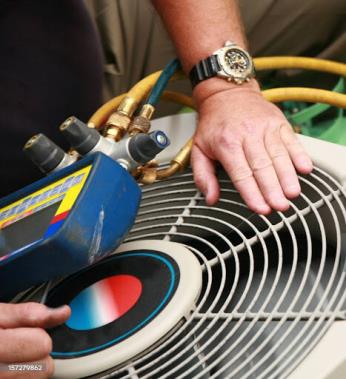 Mast technician working on outside AC unit in Ottawa and Allegan County