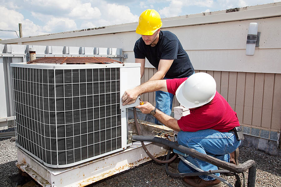 Mast HVAC technicians working on an RTU in Ottawa and Allegan County